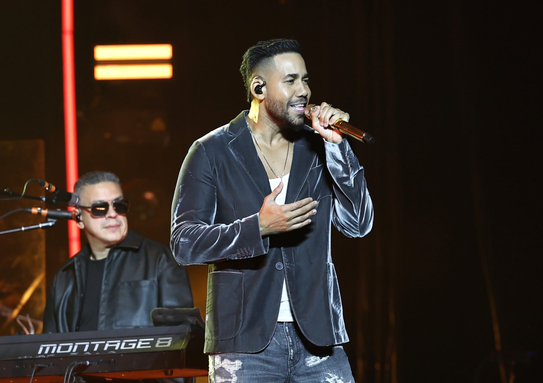Romeo Santos performing on stage.